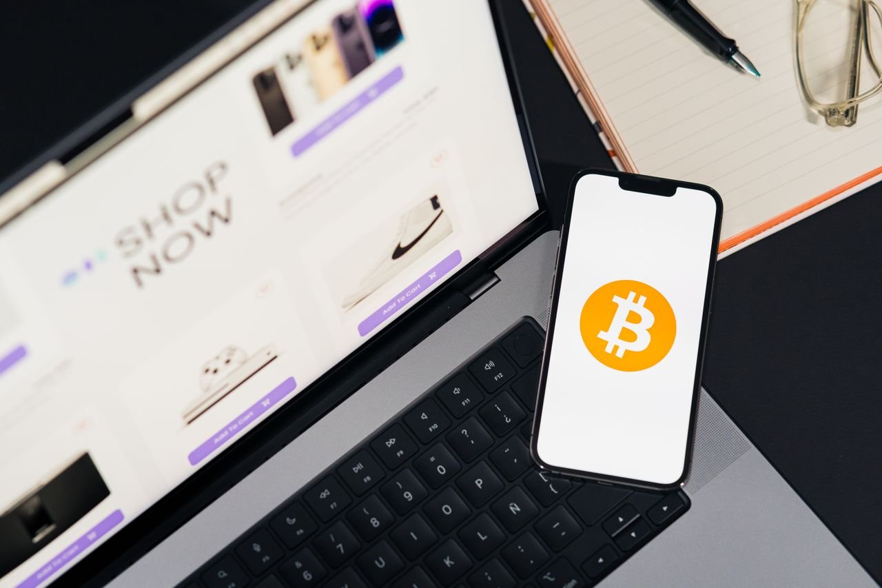 Services Laptop and smartphone with Bitcoin symbol, depicting digital shopping