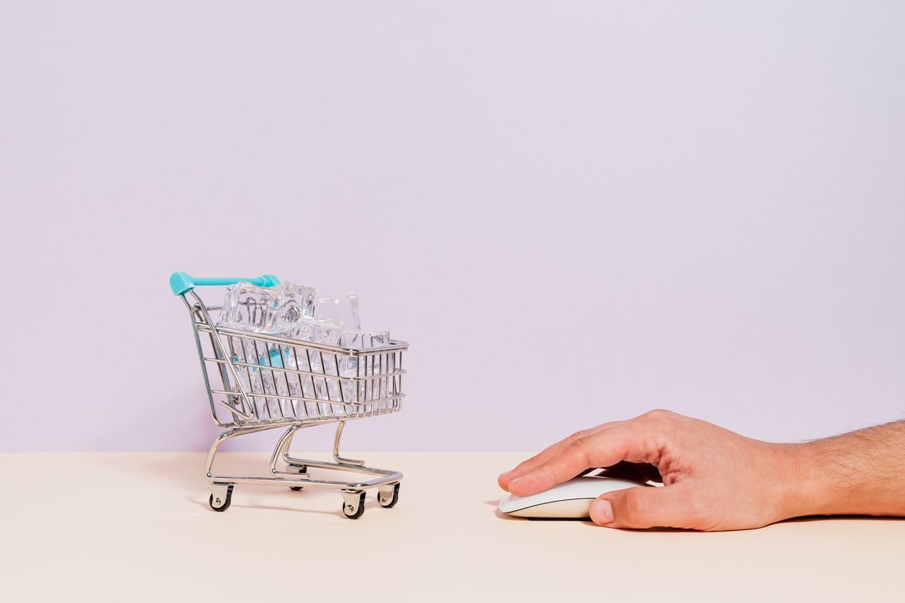Crafting Captivating Headlines: Your awesome post title goes here Conceptual image of a hand on a mouse next to a miniature shopping cart filled with ice cubes, symbolizing online shopping.
